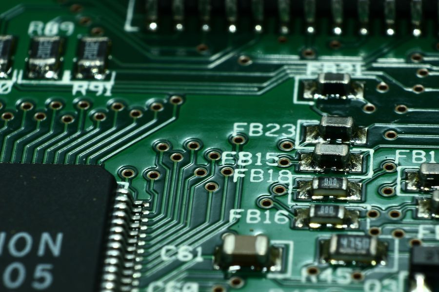 Close-up of a printed circuit board with surface-mount components and a microcontroller